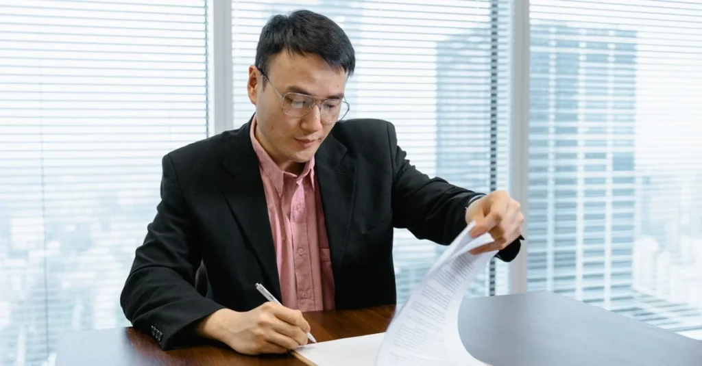 Executive reviewing CreatorIQ alternatives contract at modern office desk with city skyline view.